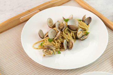 Pasta with clams in a white bowl