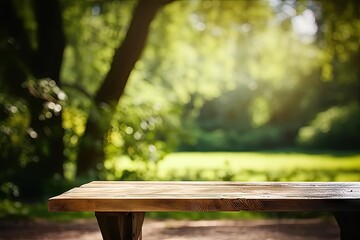 Naklejka premium Rustic wooden table in nature. Blank board for summer and spring creations surrounded by greenery and bathed in sunlight