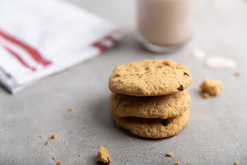 Chocolate chip cookies with chocolate milk in the background