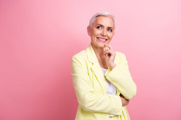Photo of senior businesswoman in yellow suit touch chin looks mockup select new design for business...