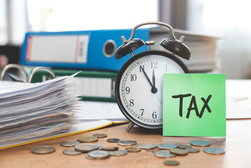 Tax concept with clock and papers