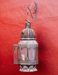 old lantern on a red wall