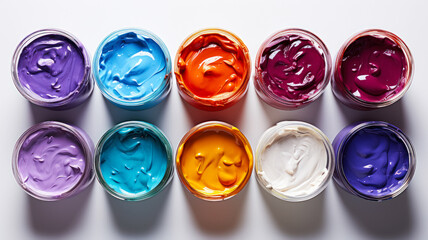 Multicolored acrylic paints in jars on white background, flat lay, product advertising banner or background for product concept