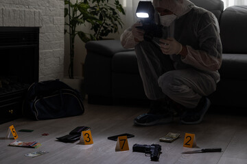 Forensics researcher photographing a blood at a murder scene - obrazy, fototapety, plakaty