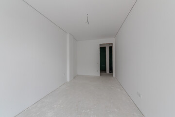 New empty room under construction. Plaster walls. New home. Concrete walls. Interior renovation.