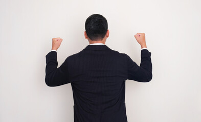 Back view of successful businessman clenched fist