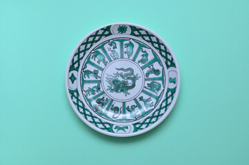 vintage plate with an image of a Chinese dragon on a green background