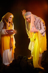 A couple in love or a married couple in stylized Eastern clothing from Israel, Palestine, Iran, Pakistan together. A tender photo session in the style of the Middle East and the Bible