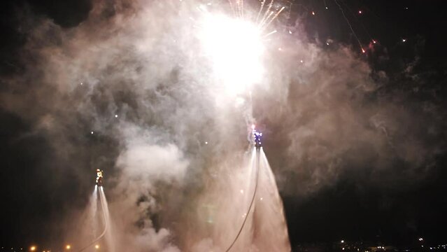 flyboarding against the background of fireworks, colorful fireworks on the beach