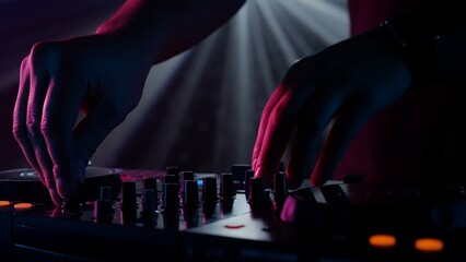 DJ's Hands Adjusting Sound Mixer Under Club Lights