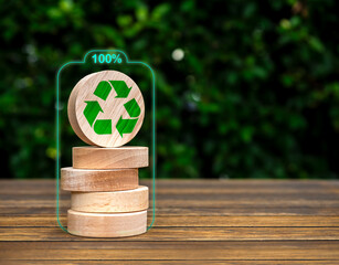 Renewable energy. Green recycle icon on round wooden blocks stack on green leaves background with...