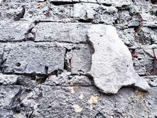 Background and texture with gray old brick and plaster remnants. Abstract background, texture, pattern, frame, place for text and copy space