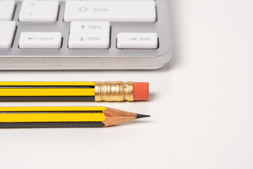 View of keyboard and mouse of a modern computer with pencils.