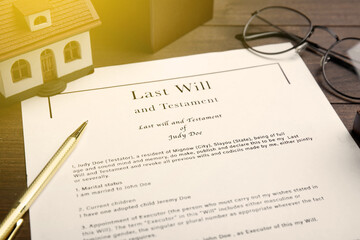 Last Will and Testament, house model, glasses and pen on table, closeup