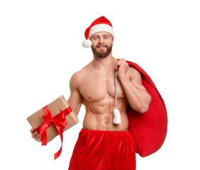 Attractive young man with muscular body in Santa hat holding bag and Christmas gift box on white background