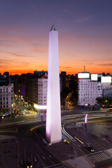 Aerial view of the iconic Obelisk of Buenos Aires, Argentina. There is a colorful sunset in the...