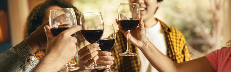 Close up of happy friends drinking wine and enjoying time together at holiday party at home - obrazy, fototapety, plakaty