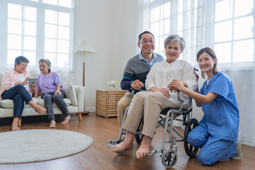 Asian young nurse support couple senior older man and woman in a wheelchair. elderly mature and a...