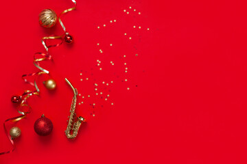 Festive red Christmas and New Year background with Miniature golden saxophone copy and Christmas...