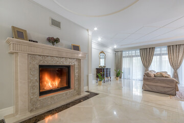 The interior of the living room in neoclassical style in a luxurious mansion. Fireplace .with...