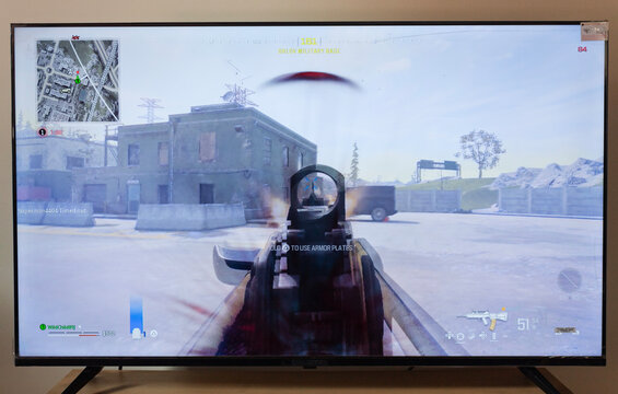 new Call of duty modern warfare III warzone screen shot with a firt person operator view shooting an assault rifle into urzikistan map in a smart tv