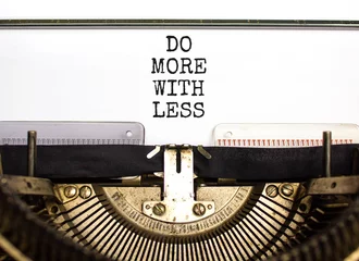 Fotobehang Do more with less symbol. Concept word Do more with less typed on beautiful old retro typewriter. Beautiful white paper background. Business do more with less concept. Copy space. © Dzmitry