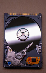 Mechanics inside a hard disk drive with platter and read write head.