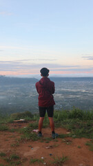 A male climber is enjoying the morning atmosphere at the top of Arang hill
