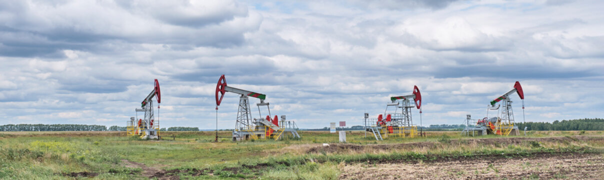 Four oil rocking chairs in field