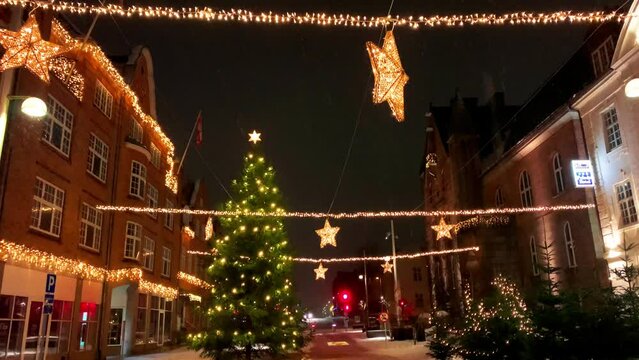  Decorated for Christmas holidays, Denmark, Copenhagen , Viborg, Shopping street in historical center of Aarhus decorated for New Year holidays, Pedestrians Christmas shopping on Stroget at night.