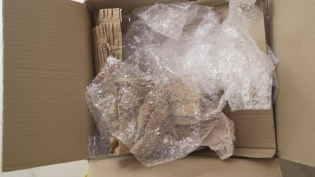 Put bubble wrap and kraft paper into a cardboard box