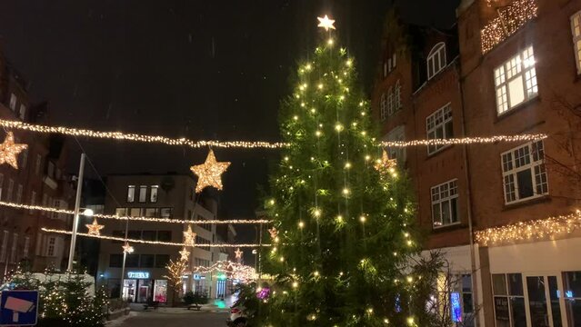 Decorated for Christmas holidays, Denmark, Copenhagen , Viborg, Shopping street in historical center of Aarhus decorated for New Year holidays, Pedestrians Christmas shopping on Stroget at night.