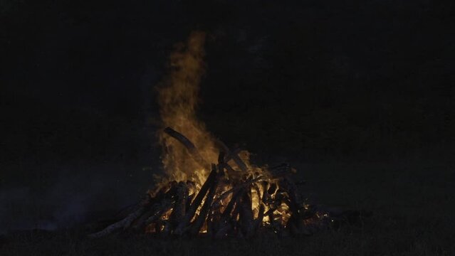 Big bonfire burning in a field in the night