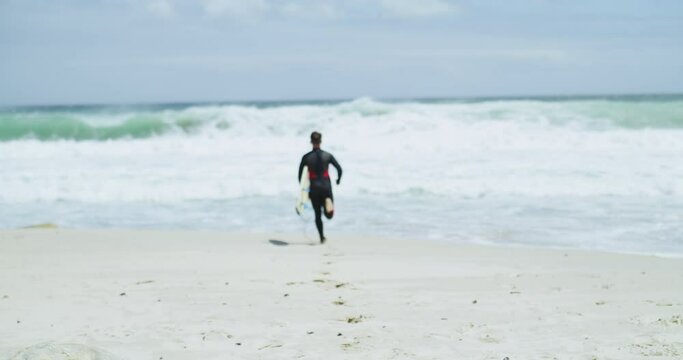 Back, running and beach with man, surfer and waves with hobby, summer and vacation with weekend break, fitness and sports. Person, outdoor and guy with sunshine, holiday and ocean with getaway trip