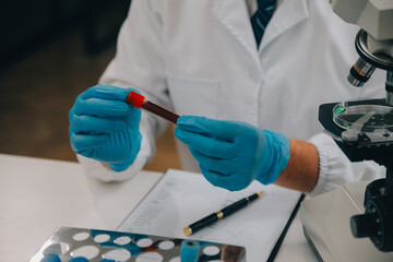 Scientist or medical in lab coat working in biotechnological laboratory, Microscope equipment for...