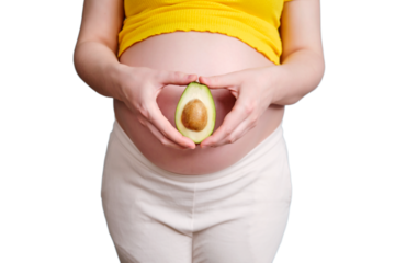 A pregnant woman holds a green avocado in her hand, isolated on a white background