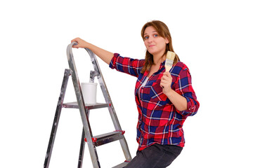 Fototapeta na wymiar A woman painter in a plaid shirt stands on a ladder with a brush in her hand, isolated on a white background