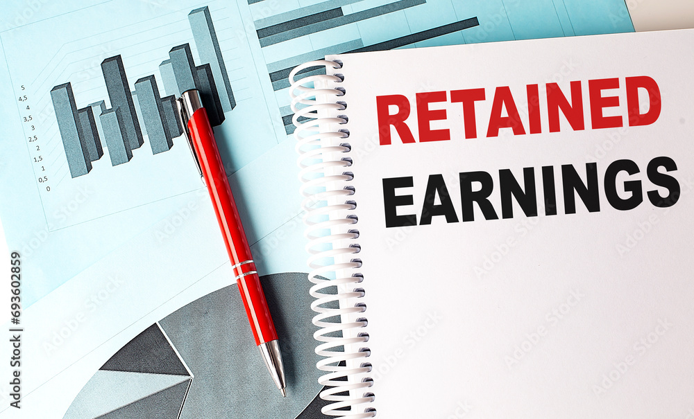 Poster retained earnings text on a notebook with pen on a chart background
