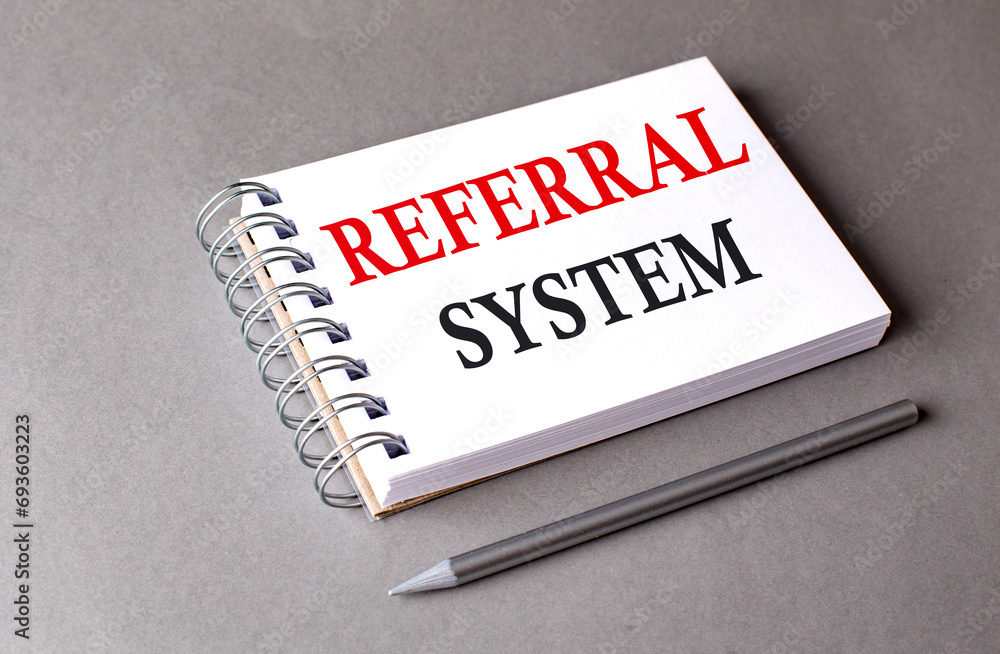 Poster referral system word on notebook on grey background