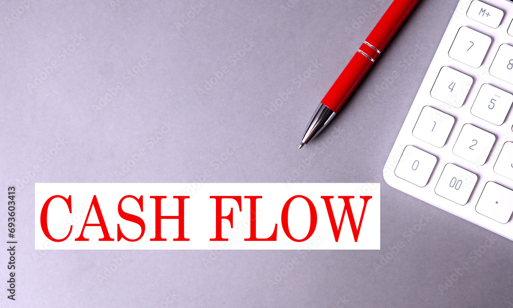 Poster cashflow text written on a gray background with pen and calculator