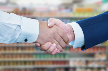 Business handshake at supermarket, Two businessman shake hand with partner to celebration...