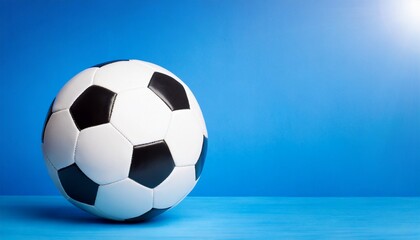 Soccer ball Isolated, blue background, text space