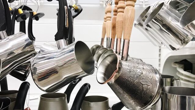Cezve pot Coffee Brewing , pot steel with wooden handle, hanging on store shelf tableware. concept coffee cooking