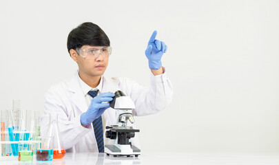Portrait Asian man student scientist Wearing a doctor gown in the lab looking hand at chemist....