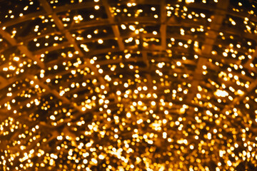 defocused orange and yellow glare garlands, New Year's tree in the city of Lisbon. Christmas lights...