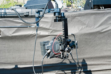 Professional television camera on a crane near the stage.