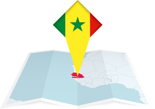 Senegal pin flag and map on a folded map
