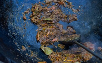 Onion, Chilies, Garlic and Others Spices and Condiments Frying in Hot Oil in a Caldron