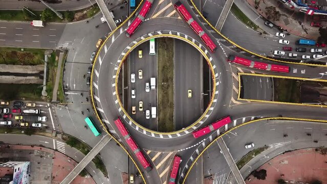 Aerial drone shot of Roundabouts in Bogota, Colombia, Latin America. Traffic in Bogota, Transmilenio. Dedicated busway on the top level. Famous roundabout full of red buses. High quality 4k footage.