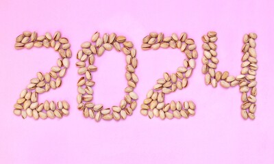 2024 Written with Pistachio Nut on Pink Background, Happy New Year 2024 Wishing Conceptual Photo